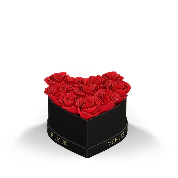 Heart-shaped black box with nine red roses and the text 'VENUS ET FLEUR' on the box