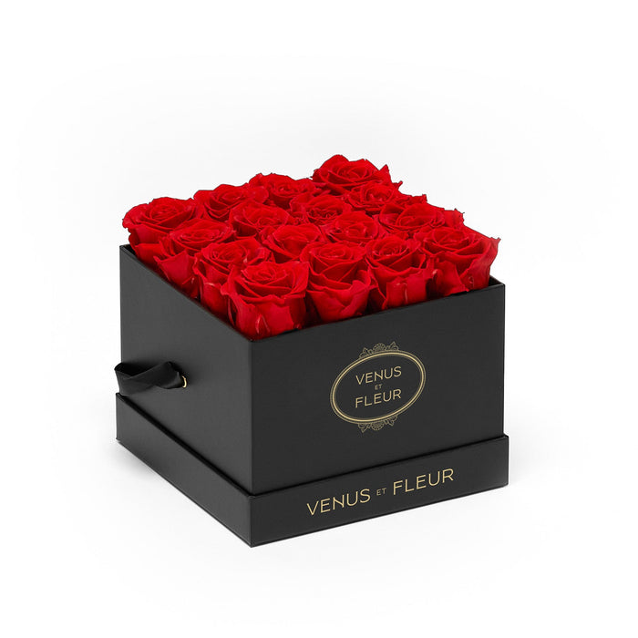Black square box filled with red roses, branded with 'VENUS ET FLEUR' on the front and base